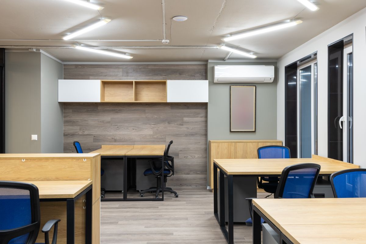 Modern open-plan office with a wall-mounted split air conditioner